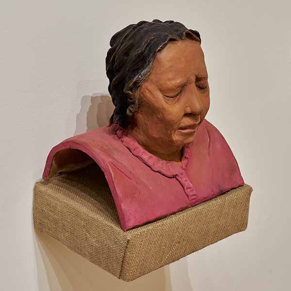 A ceramic bust of a sleeping woman
