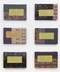 six cards with woven fabric and letterpress text on them