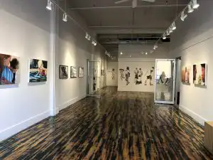 interior view of a gallery with pictures hung on the walls