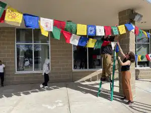 prayer flags being hung outside of a building