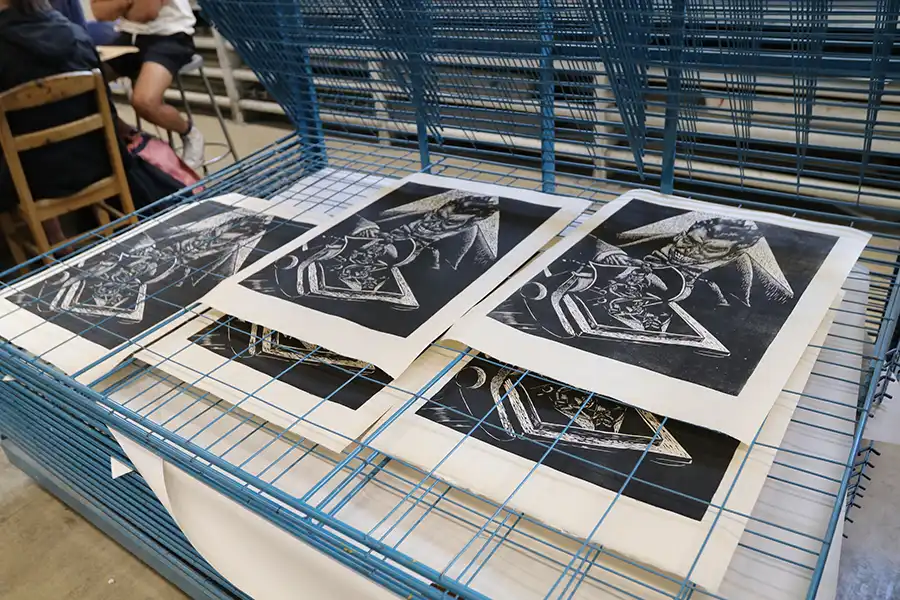 Prints drying on the rack in the printmaking studio