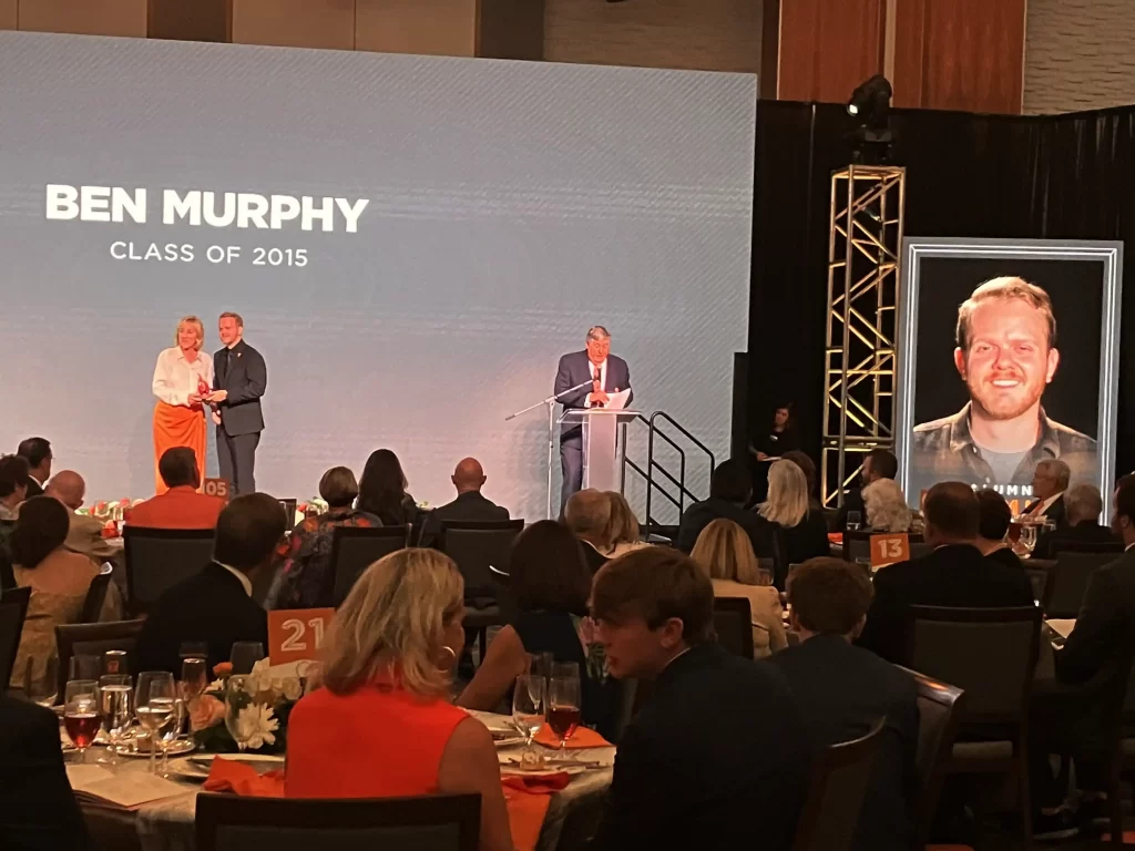 Ben Murphy receives Alumni Promise Award from Chancellor Donde Plowman.