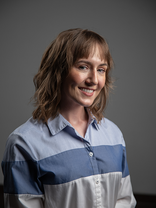 Headshot photo of Janelle VanderKelen against a gray background