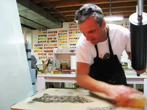 Tom Christison printing a stone lithograph from his studio in Iowa City, IA. 