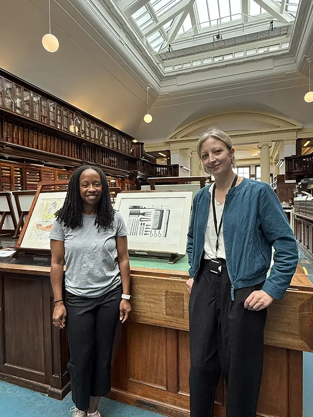 Althea with Catherine Durant stands in the British Museum in front of various prints with another person. 