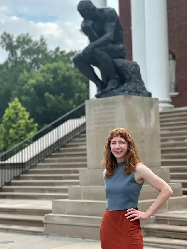 Dana Potter stands in front of The Thinker statue on the University of Louisville's campus. 