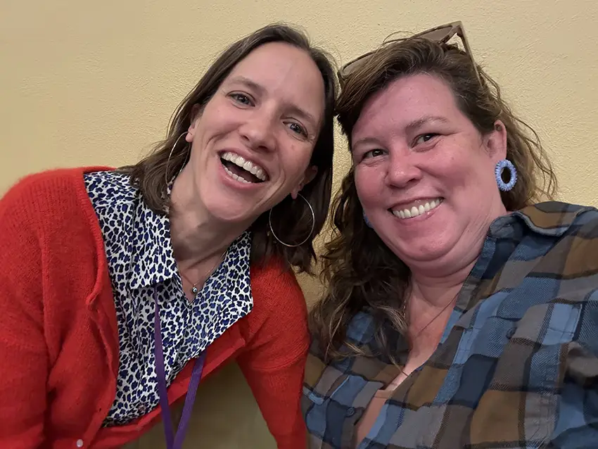 Katie Ries poses for a photo alongside a friend. 
