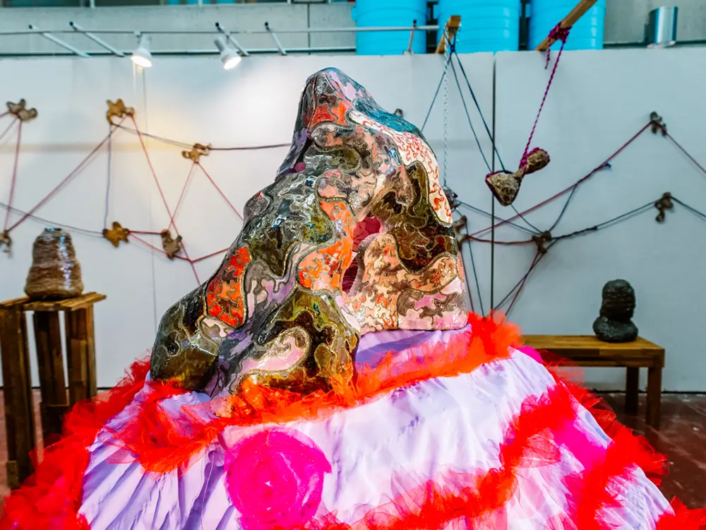 Artwork sculpture titled "Global Warming" that depicts a sculpted volcano-like structure. 